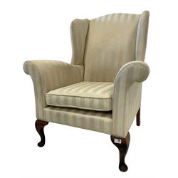 George III design wingback armchair, upholstered in striped ivory fabric with scrolled arms, raised on cabriole supports
