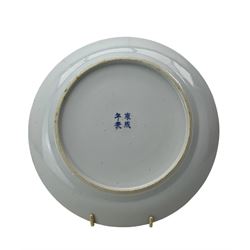 19th century Chinese blue and white plate, the central reserve painted with fighting warriors in a mountainous landscape, within scroll work borders, D24cm, together with a similar plate painted with figures by a building (2)