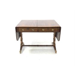 Regency mahogany sofa table, the cross banded top with two drop leaves over two drawers and two faux drawers with ebonised string inlay, raised on ring turned cluster columns with reeded arched sledge feet and brass hairy paw castors, 92cm x 71cm, H70cm