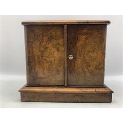 Victorian figured wanut table top cabinet fitted with two interior drawers, countersunk brass handles and enclosed by a pair of panelled doors on a plinth base W34cm x H29cm x D28cm 