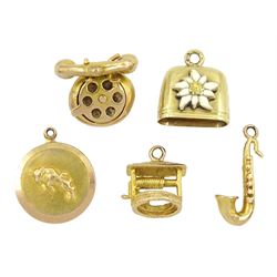 Four 9ct gold pendant /charms including telephone, wishing well, saxophone and Taurus and a 14ct gold cow bell charm