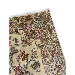 Persian Kerman cream ground rug, overall floral design, sparse field decorated with trailing flower head and Boteh motifs, repeating floral pattern border with repeating motifs