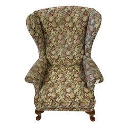 Parker Knoll - two wingback armchairs, upholstered in floral patterned fabric with cabriole supports (2)