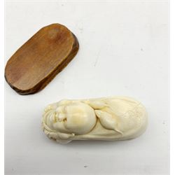 Japanese Meiji carved ivory Okimono or walking stick handle in the form of Daikoku carrying a large sack over his shoulders with rats crawling over it, on associated stand, signed, L8.5cm