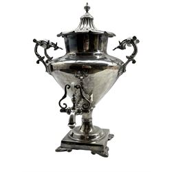 Victorian plated baluster tea urn with ceramic handles stamped 'Warranted Best London Manufacture' with fluted cover and square base with leaf scroll bracket feet H48cm
