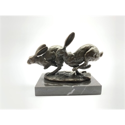 Bronze figure group, modelled as two hares in chase, signed Nick and with foundry mark, raised upon a rectangular marble base, H12cm overall
