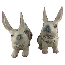 Pair of mid 20th century Chinese pottery Rabbits, each in a different pose and enamelled with fruit and flowering branches, H27cm max