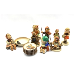 Group of Goebel figures comprising Skier Boy no. 59, Book Worm, School Girl no. 81, Happy Pastime ashtray no. 62 together with four other Goebel figures and six plates 