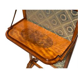 Late George III satinwood fire screen, upholstered in floral blue fabric, fold-down lipped tray with central figured walnut oval inlay, on splayed supports joined by stretchers 
