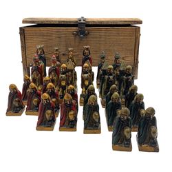 Moorish carved wood and lacquer figural chess set, housed in a carved softwood metal bound casket, L44cm x H23cm