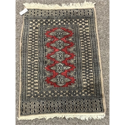 Persian Afghan design Bokhara ground rug, with repeating gul motif on red field, enclosed by multi line border, (200cm x 130cm) together with another Afghan style rug, (95cm x 60cm) 