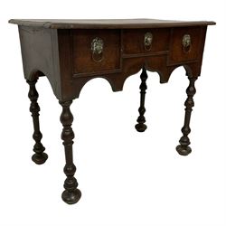 18th century oak lowboy, rectangular top with moulded edge, fitted with three drawers with brass lion mask handle plates and ring handles, shaped apron over turned supports 