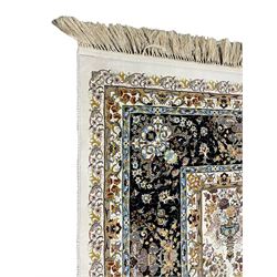 Persian design densely knotted ivory ground carpet, the field decorated with repeating motifs depicting floral urns, guarded indigo ground border with trailing foliate and flower head decoration
