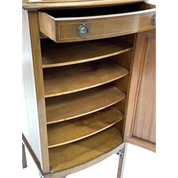 Edwardian walnut and boxwood strung bow front sheet music / side cabinet fitted with one drawer and cupboard enclosing three shelves, raised on square supports
