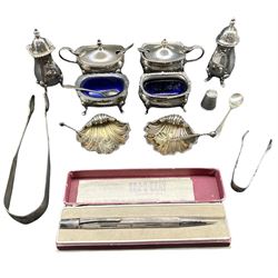 Silver three piece condiment set Birmingham 1968 Maker Garrards, another set  by Mappin & Webb Birmingham 1965, pair of silver shell shape salts silver Yard o-Led Aristocrat  pencil, two pairs of sugar tongs and a thimble 