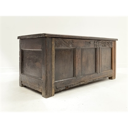 18th century three panel oak coffer carved with scrolls and raised on stile supports, W123cm, H56cm, D54cm