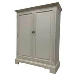 Contemporary traditional white painted cupboard, two panelled doors enclosing two shelves, on bracket feet
Provenance: From the Estate of the late Dowager Lady St Oswald