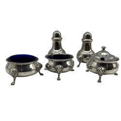 Silver three piece circular condiment set, with lion mask and paw feet by Pearce & Sons Ltd, London 1937/39 and a pair of similar pepperettes , London 1934, Maker Walker and Hall approx 10.5oz