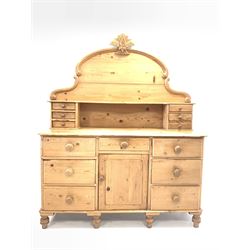 Victorian stripped pine dresser fitted with seven drawers and centre cupboard, raised back with six further drawers W136cm, H167cm, D46cm