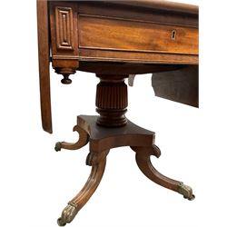19th century mahogany drop leaf  table, the drop leaf top over one frieze drawer, raised on one reeded column leading into four splayed supports, terminating in brass hairy paw castors 