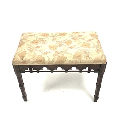 Victorian mahogany duet stool of Gothic design, with upholstered seat over arch carved apron, raised on carved square tapered supports, W74cm, H53cm, D46cm