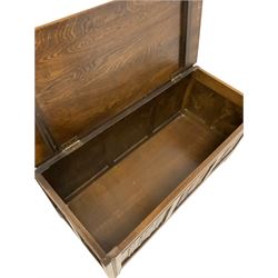 Mid-20th century oak blanket box, the hinged lid over carved linen front, raised on stile supports W105cm, H50cm, D45cm