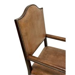 Pair oak open armchairs, high shaped arch back, upholstered in tan leather with studded bands, turned supports and front stretcher, joined by a series of plain stretchers