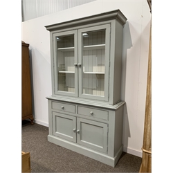 Painted pine dresser, the top section with projecting cornice over two glazed doors enclosing two adjustable shelves, two drawers and two cupboards under on skirted base, W130cm, H205cm, D44cm