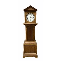 Oak cased granddaughter clock, pointed pediment over circular white painted dial with Roman numeral chapter ring, the eight day Westminster chiming movement striking the quarter hours hammers on four gong rods H108cm