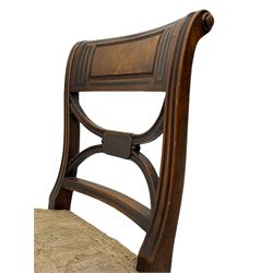 Pair of Regency mahogany chairs, the cresting rail inlaid with trailing geometric ebony banding and moulded figured panel, curved x-frame back with moulded uprights, on sabre front supports with single ebony band