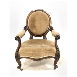 Victorian mahogany open armchair, leaf carved crest rail over scrolled arm rests and shaped apron, upholstered in brown fabric, raised on scrolled cabriole supports and castors 