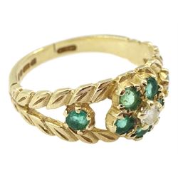 9ct gold emerald and diamond flower head cluster ring, with pierced leaf design emerald set shoulders, London 1976