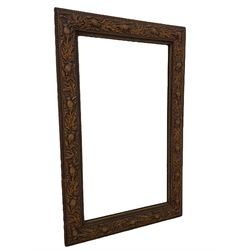 Early 20th century wall mirror, the frame moulded with thistles and trailing foliage, plain mirror plate