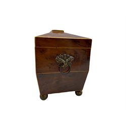 George III burr yew wood sarcophagus shape tea caddy, the interior with two covered containers, ivory escutcheon, metal ring handles and brass ball feet W19cm