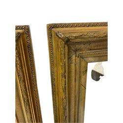 Pair of 20th century giltwood and gesso rectangular wall mirrors, in moulded frame with fluted decoration, applied foliage mouldings to corners and foliate moulded outer edge, plain chamfered slip with plain glass plate
