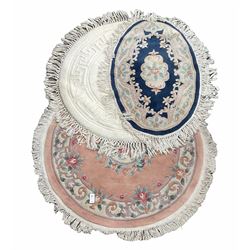 Chinese circular washed wool pink ground rug with floral design (D140cm) together with a Chinese blue oval ground rug with similar design (W145cm) and a Circular white Chinese washed wool ground rug (D155cm) 
