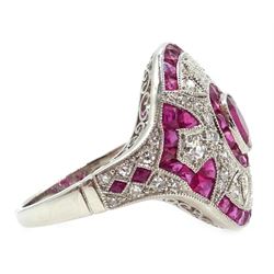 Platinum ruby and diamond cocktail ring, central oval ruby, with calibre cut rubies and open work diamonds surround