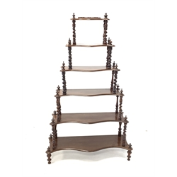 Victorian mahogany serpentine front waterfall whatnot, six tiers each raised on spiral turned supports 