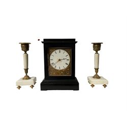 French  - mid-19th century ebonised 8-day campaign clock, with two associated white marble candle sticks, engraved gilt metal dial mask and white dial with Roman numerals and steel moon hands, timepiece movement wound and set from the rear, with pendulum lock. Candle sticks 16cm high.