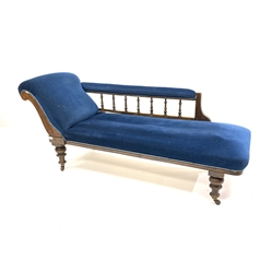 Late Victorian walnut framed chaise longue, with blue velvet upholstery, raised on turned supports and ceramic castors, L178cm
