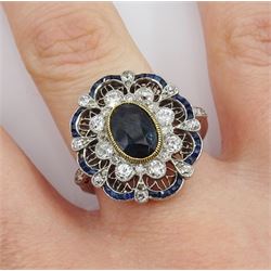 Platinum oval cut sapphire and old cut diamond cluster ring, in an openwork setting with calibre cut sapphire and diamond set border, central sapphire approx 1.65 carat