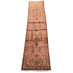Persian red and pink ground runner rug, overall floral design with Herati motifs, guarded border decorated with stylised flower heads, 375cm x 85cm