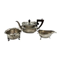 Small silver rectangular teapot with gadrooned edge, ebonised handle and lift, the base engraved and dated 1908, silver sauceboat Chester 1904 and a sugar bowl Birmingham 1907 (3)