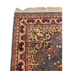 Turkish pale peach ground rug, overall geometric design (142cm x 85cm); and a Persian design blue and pink ground rug, overall floral design (190cm x 125cm)