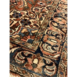 Persian design red ground rug, central medallion on busy field decorated with interlaced and stylised foliate