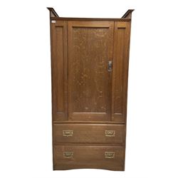 Oak wardrobe with one panelled door opening to reveal interior fitted for hanging with a falling side trouser press over two long drawers, raised on a skirted base W96cm, H194cm, D56cm 