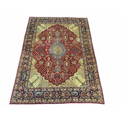 Persian red and gold ground rug, central medallion on busy red field, enclosed by border 310cm x 421cm