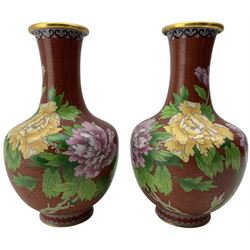 Pair of Japanese cloisonne vases, decorated with flowers, prunus and butterflies on a red ground, H26cm