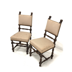 Pair of early 20th century carved oak chairs, with lion mask finials over upholstered seat and back rest, raised on turned and block supports united by 'H' stretchers, W47cm