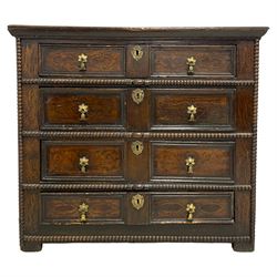 17th century Jacobean oak chest, rectangular moulded edge over four drawers with panelled sides, the facias painted with scrolling floral decoration and faux panel moulded edge, flanked by applied carved beading, raised on stile feet